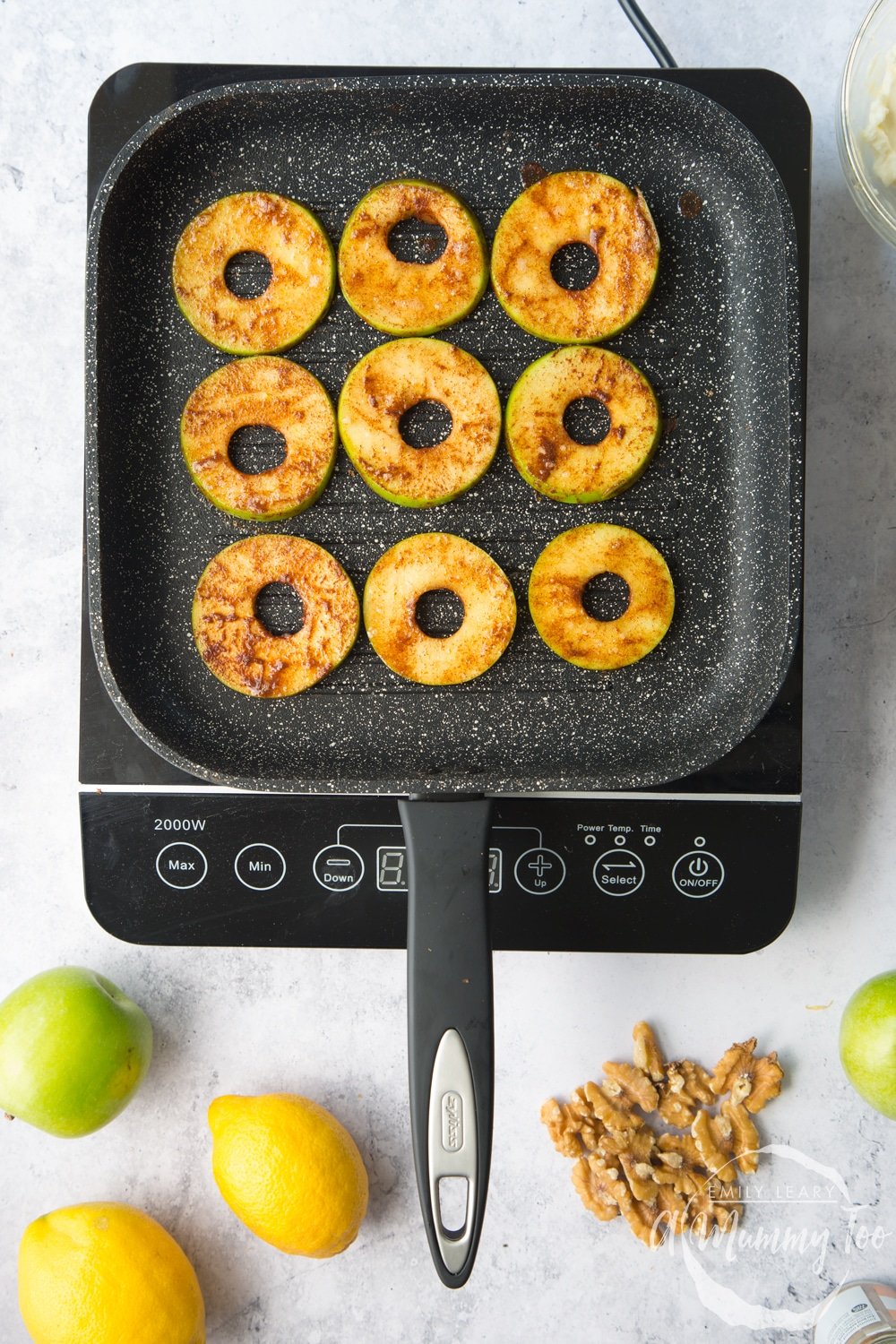 cinnamon coated apple slices in a griddle pan