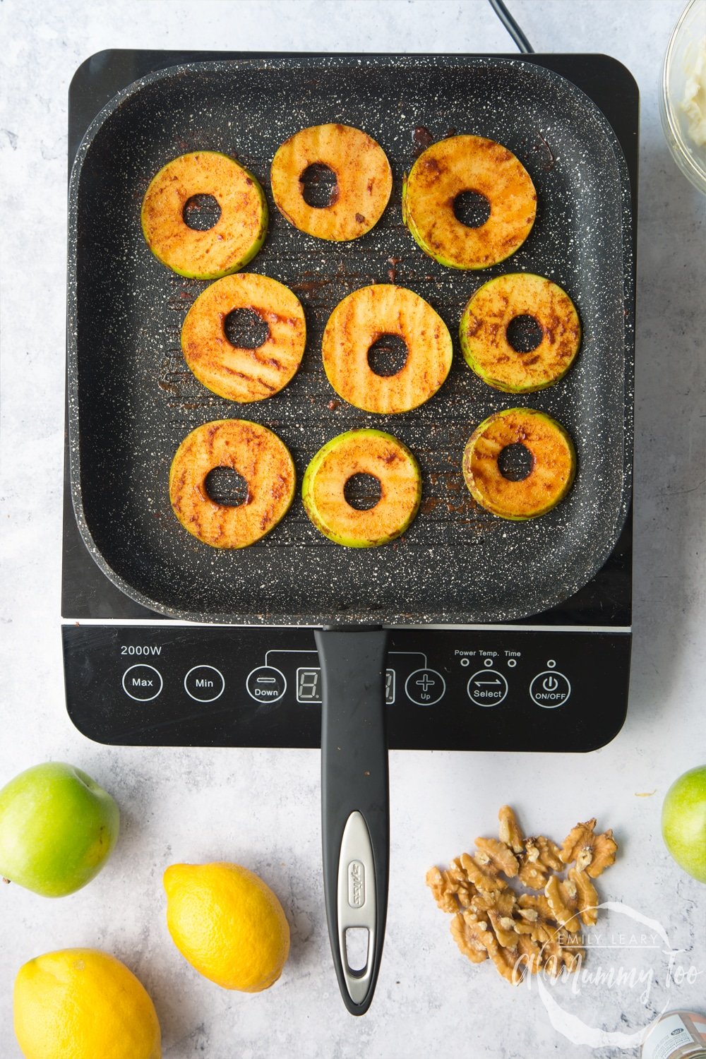 cinnamon coated apple slices in a griddle pan