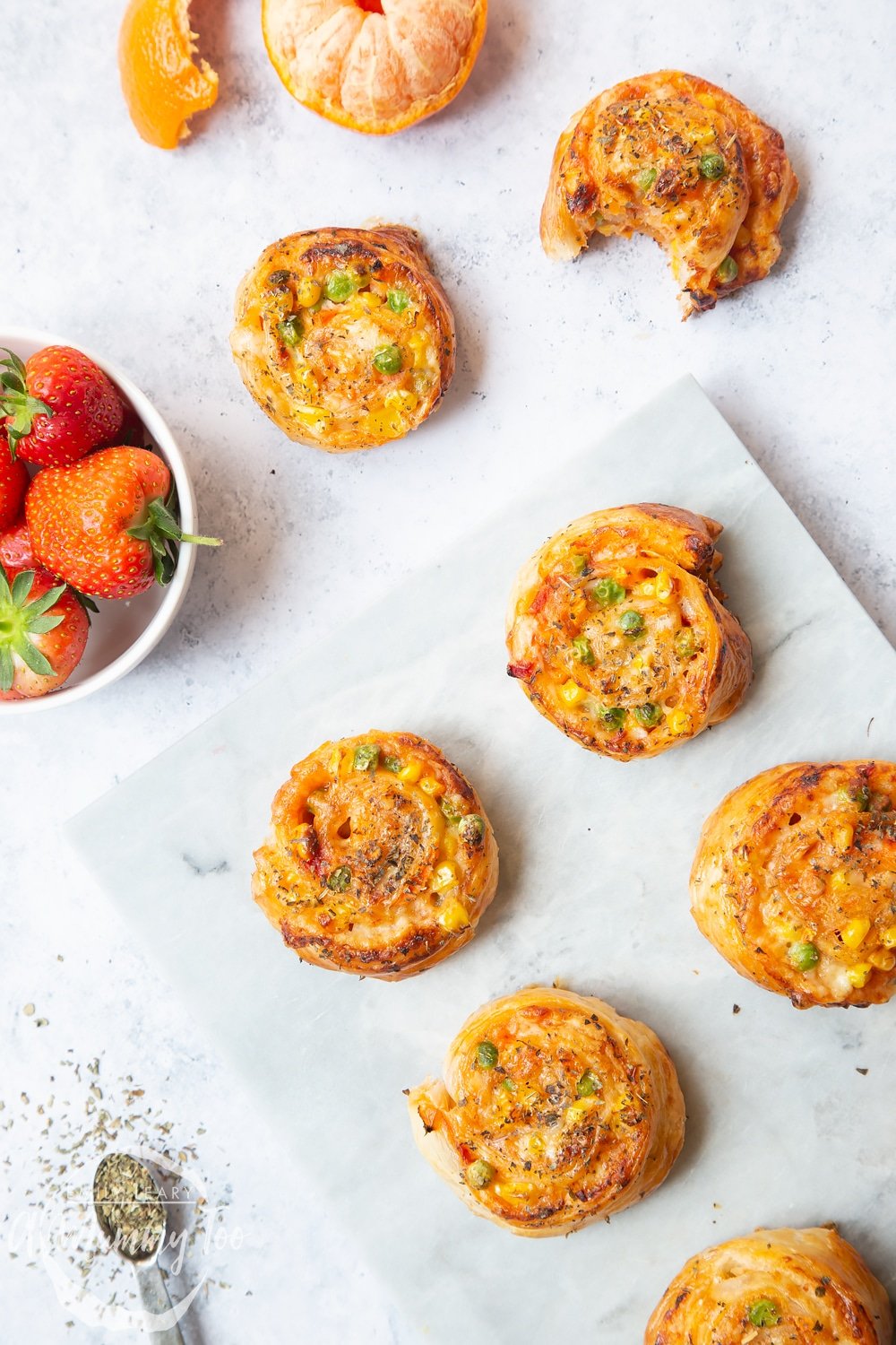 Enjoy these tasty veggie pizza roll-ups with friends and family! Served with strawberries and oranges for a lunch time snack.