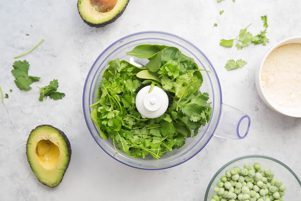 Mix avocado, peas, spinach, herbs, cheese and milk in a food processor