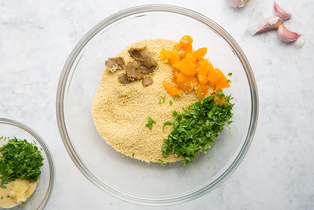 Herby couscous ingredients in a glass bowl