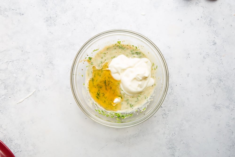 Yoghurt and honey are added to the lemon tahini sauce mix