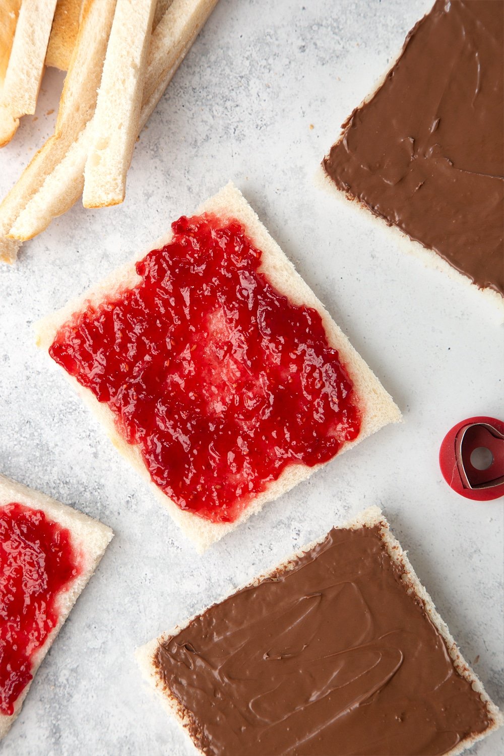 Separate the slices and top two with strawberry jam, two with chocolate spread