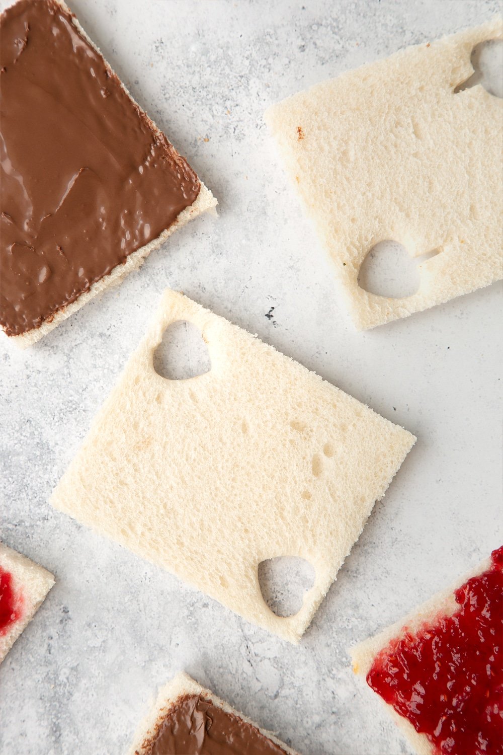 Cut out hearts and spades in your slices of bread, using cutters or scissors