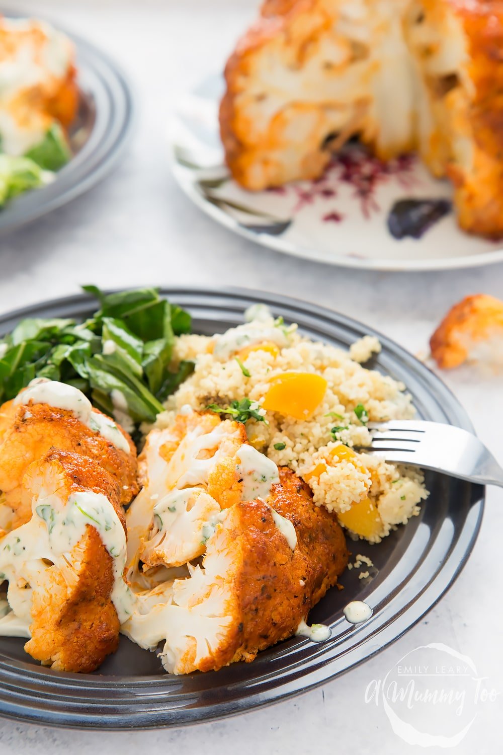 Harissa roasted cauliflower served with spring greens and herby couscous