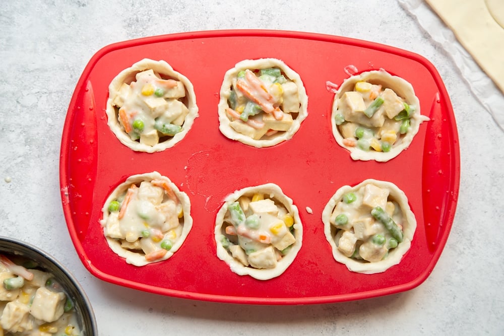 Preparing the mini vegan pies for baking