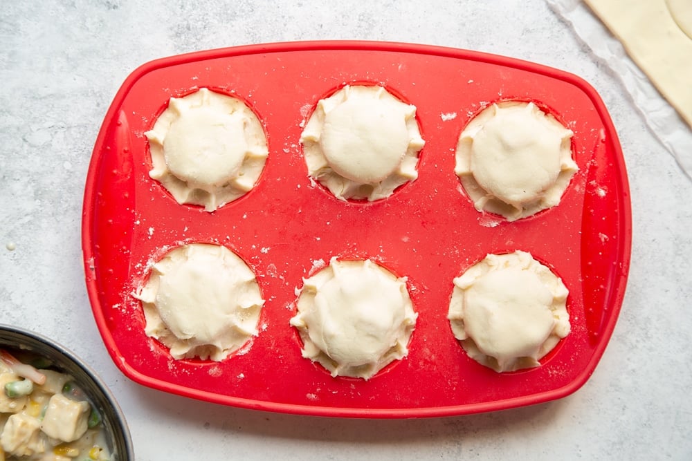 Preparing the mini pies for baking