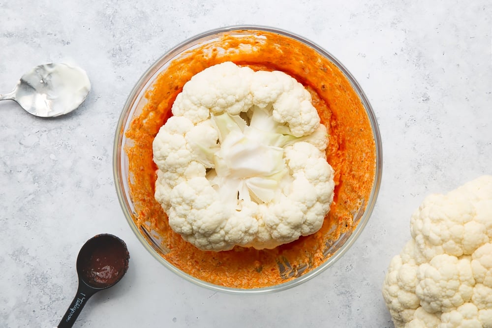 Cauliflower top-down in the bowl of harissa sauce