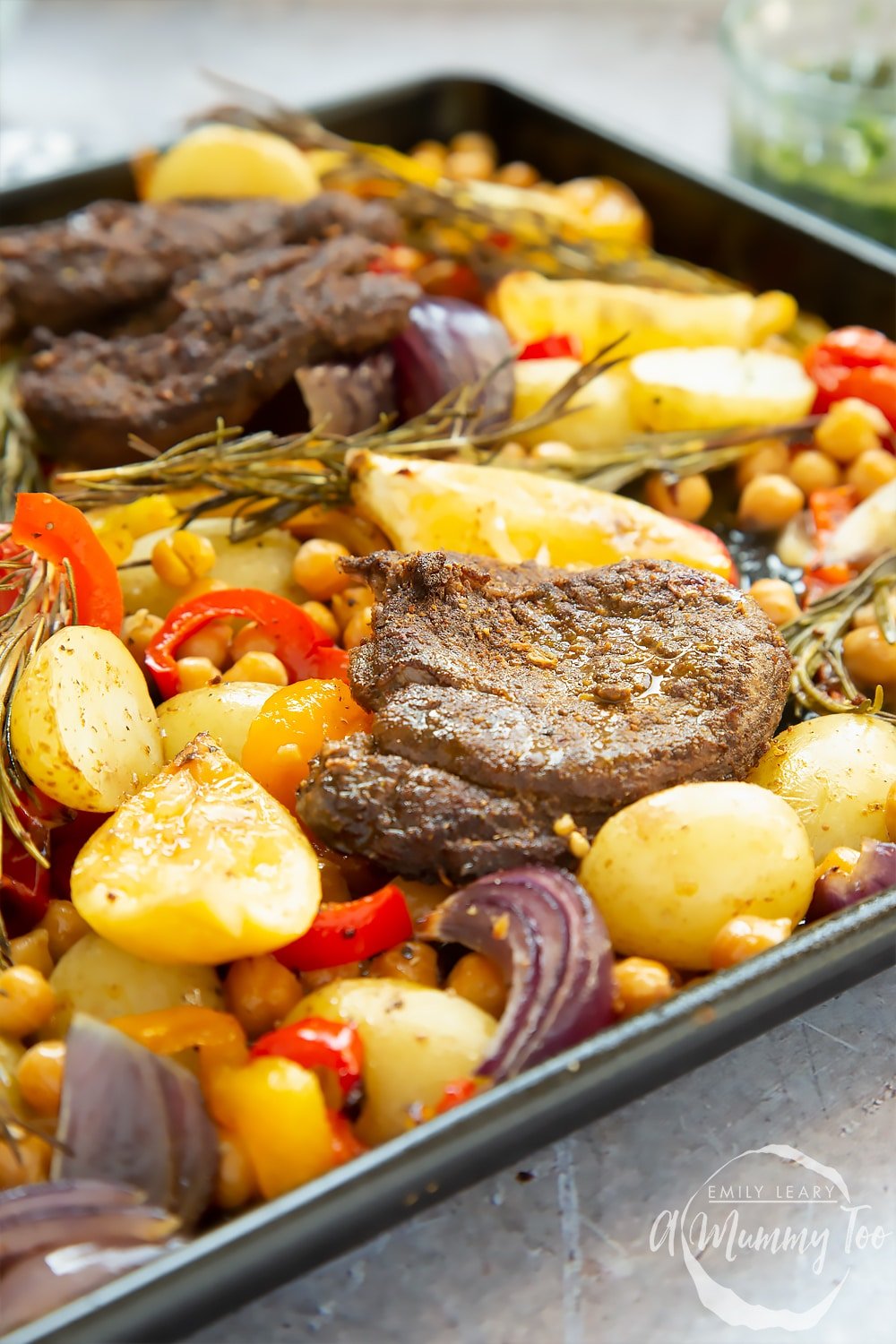 Close up of a lamb steak and veg sheet pan meal