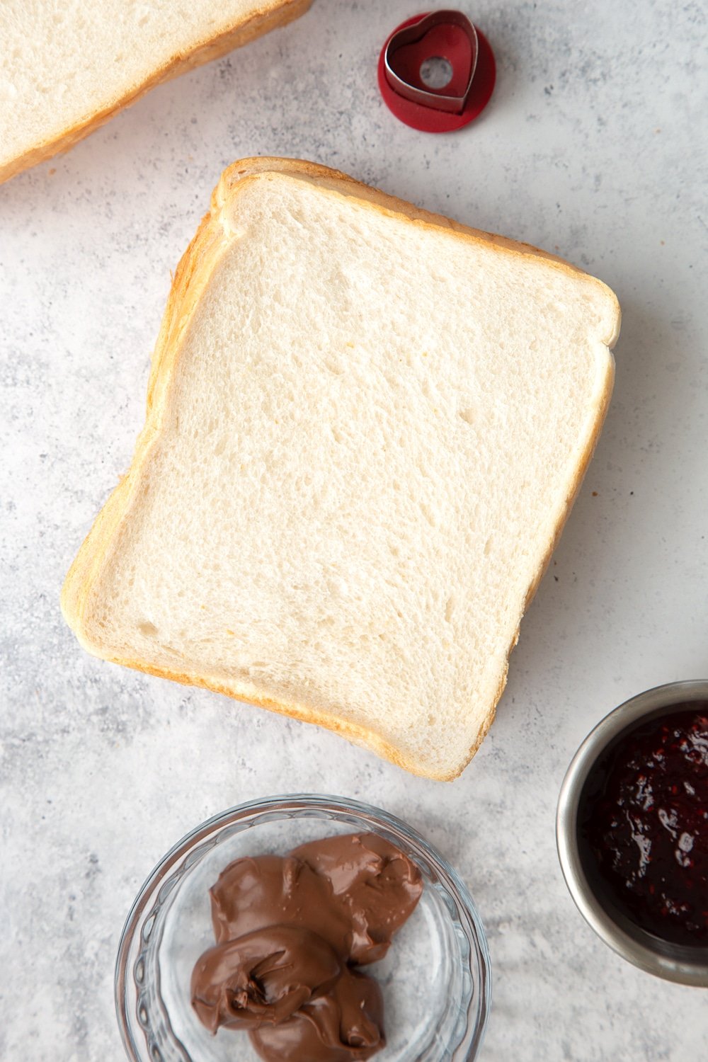 Stack your slices of bread, ready to make your playing card sandwiches