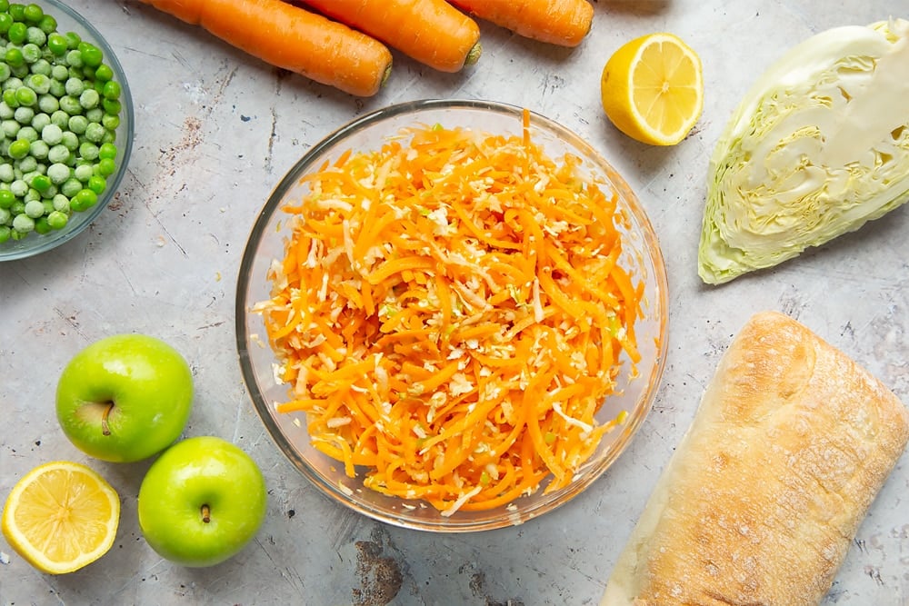 Making coleslaw with cabbage, carrots and apple