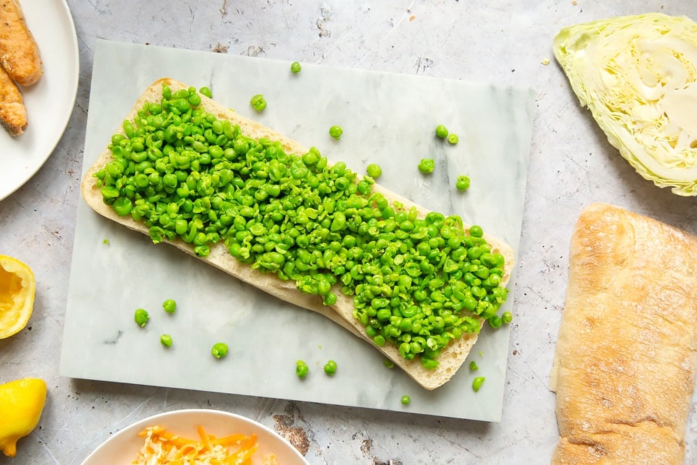 Sliced bread topped with mushy peas 