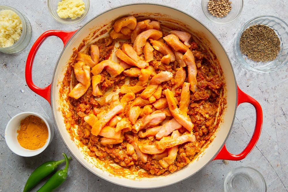 Strips of pork are added to the pan