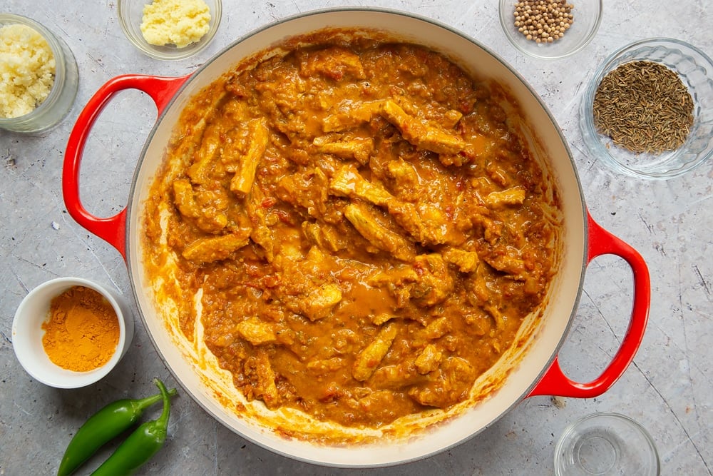Coconut pork curry cooking in a pan