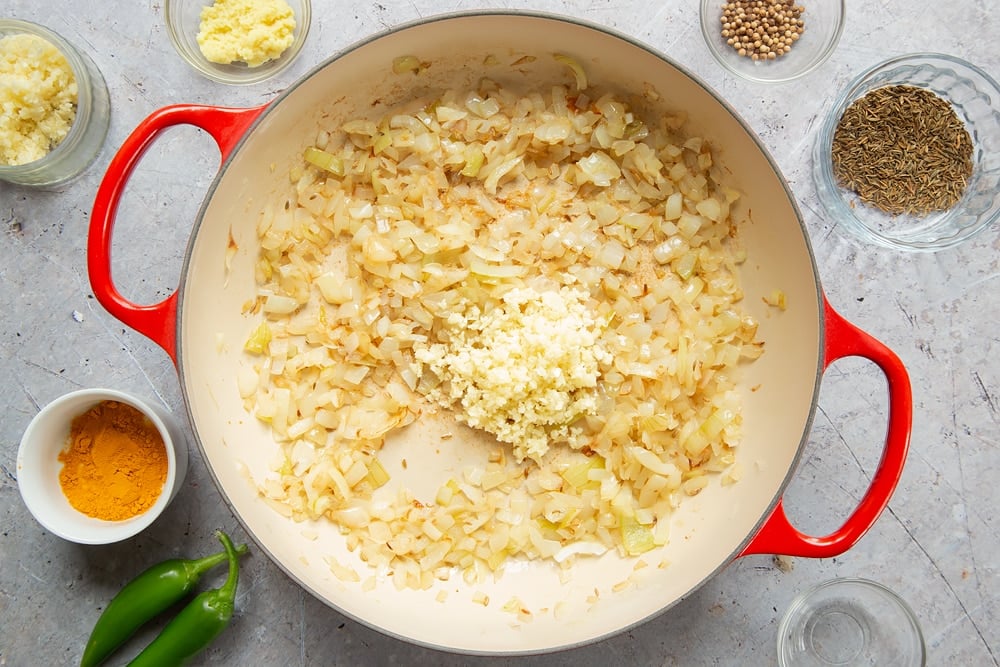 Adding garlic to the frying pan 