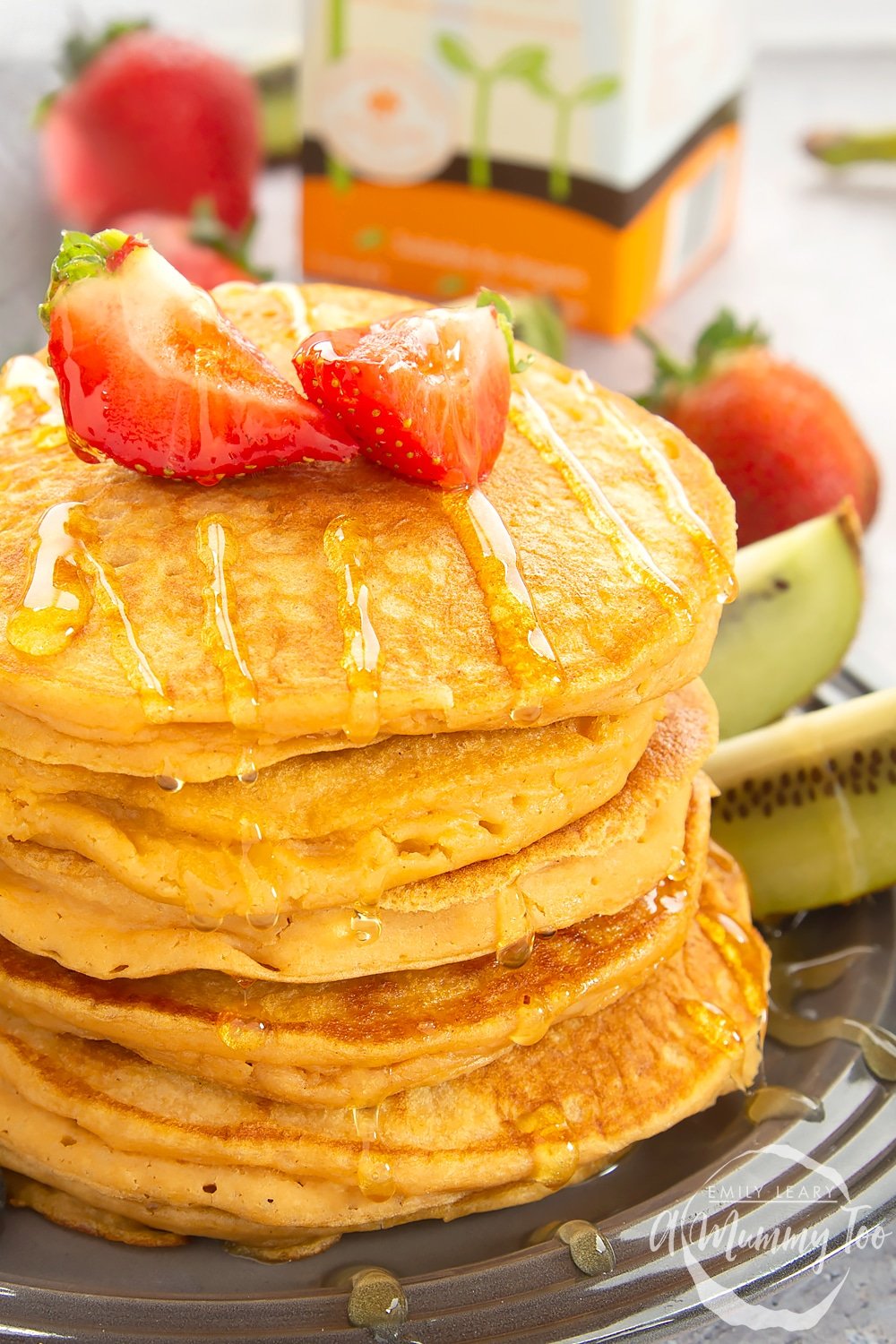 Stack of sweet potato pancakes topped with cut strawberries