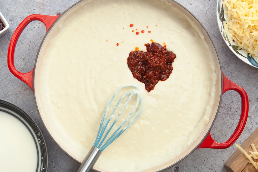 Add harissa paste to the mac and cheese sauce