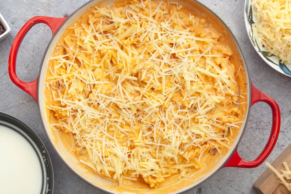 Pasta in cheese sauce, topped with grated cheese 