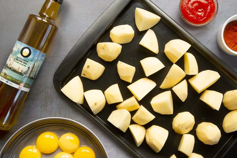 Diced potatoes on a roasting tray