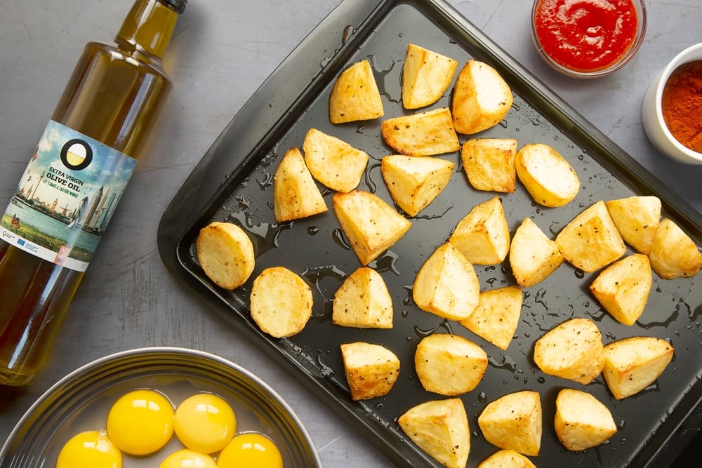 Baked diced potatoes on a baking tray