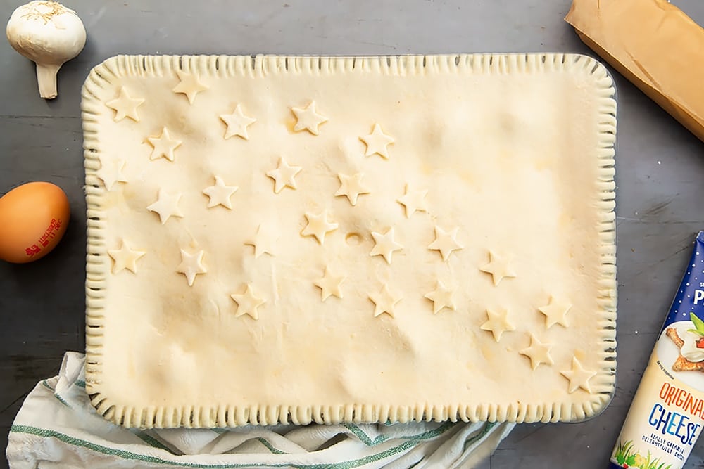 Brush with an egg wash and make a small hole in the centre of the pie to allow steam to escape