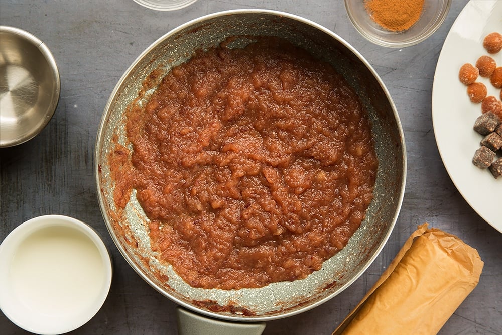 Thick red applesauce in a pan