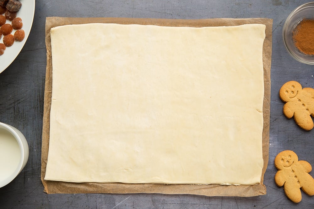 Puff pastry sheet on a board lined with baking paper