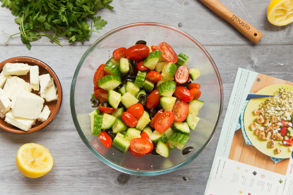 Seasoned cucumber, tomatoes and olives in a bowl