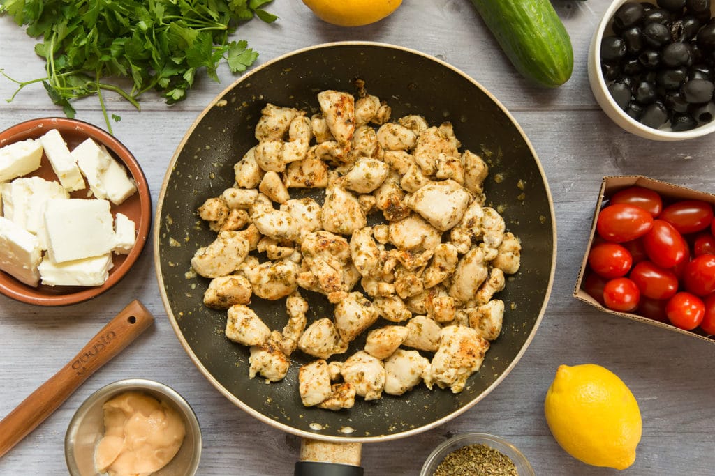 The seasoned, cooked diced chicken in a frying pan