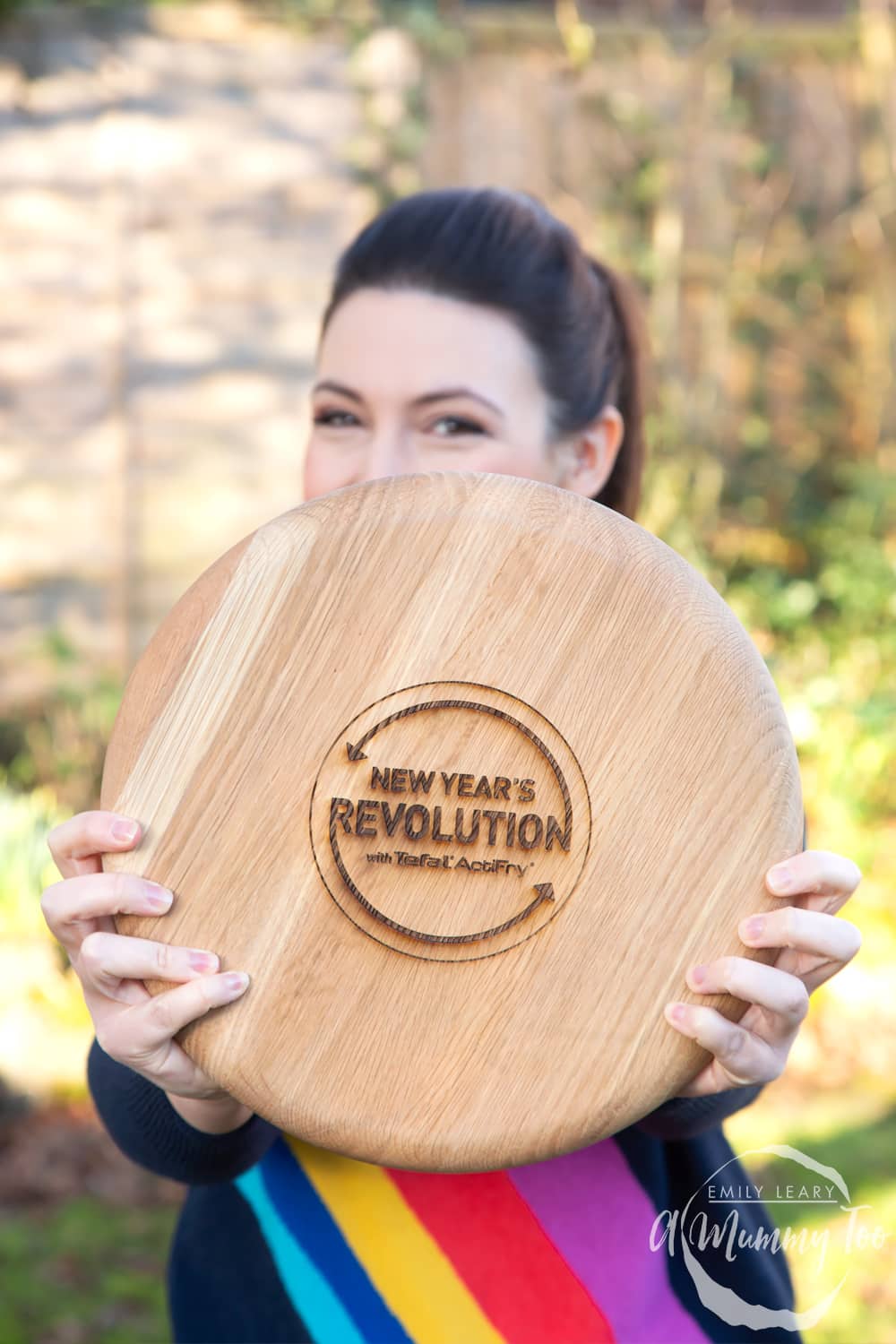 Emily Leary holding a 'New Year's Revolution with Tefal ActiFry' chopping board