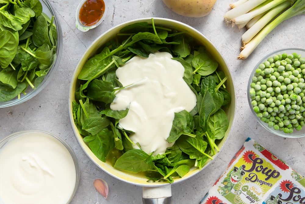 Spinach and yogurt are added to the fresh green soup mixture
