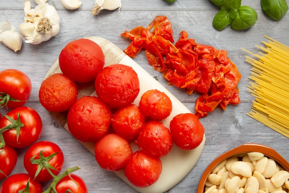 Peeling the skin off freshly boiled tomatoes