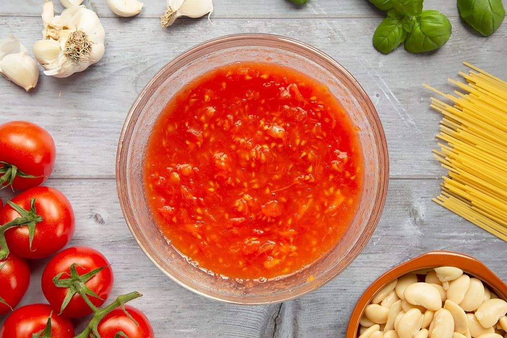 Crushing tomatoes into a tomato sauce