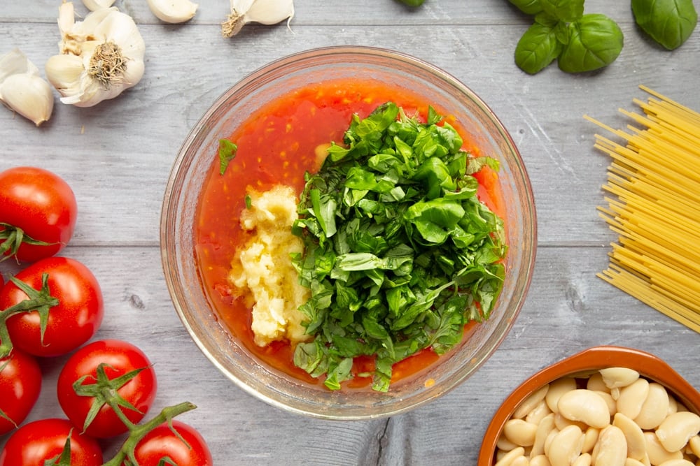 Garlic, salt and basil are added to the tomato sauce