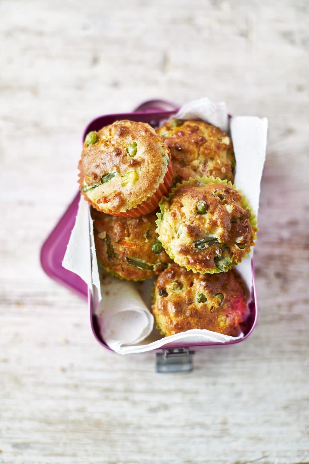 Overhead shot of Savoury Lunchbox Muffins served on a pink lunchbox