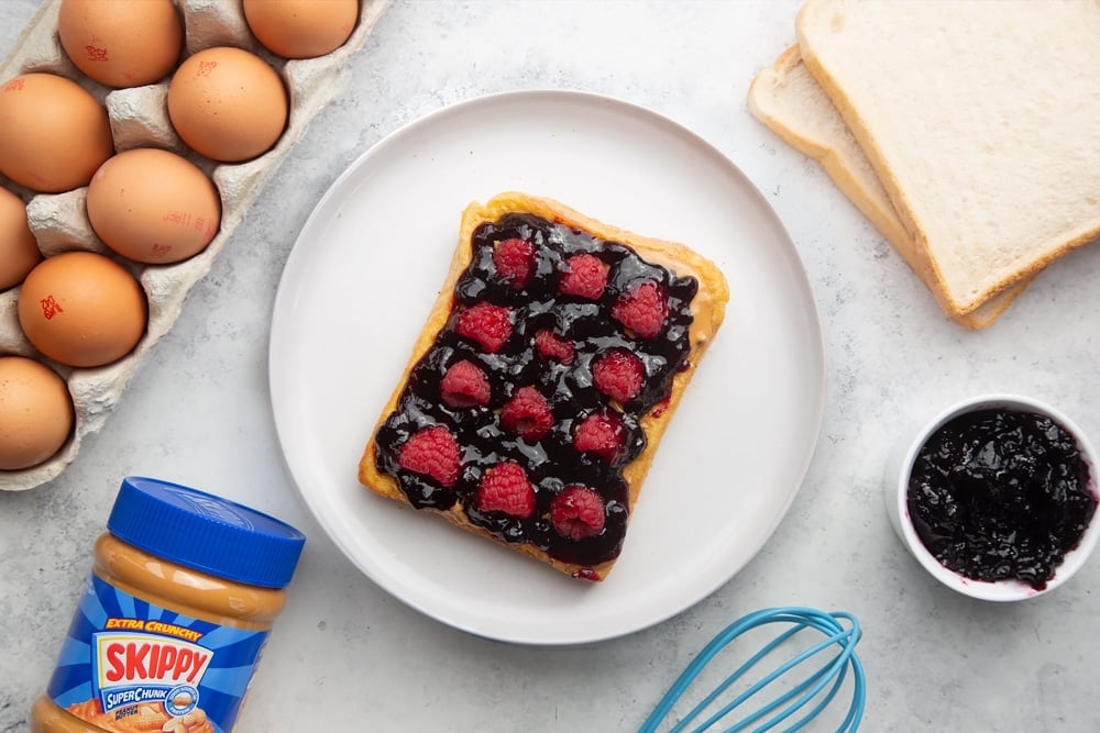 Blueberry jam is added to the French Toast topped with peanut butter 