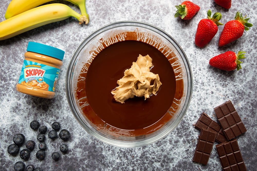 Adding the creamy Skippy peanut butter to the mixture for the peanut butter brownies