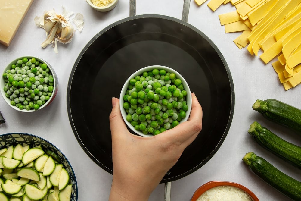 Peas being added to boiling salted water.