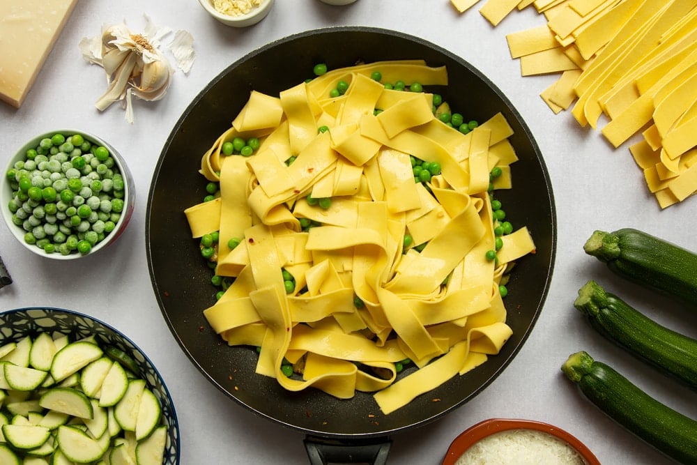 Peas and cooked lasagne sheets cut into strips, drained and added to the frying pan.