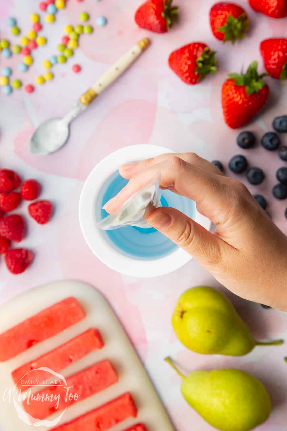 YoPop frozen yogurt maker with a clear yogurt pop bag on the top held by a hand.