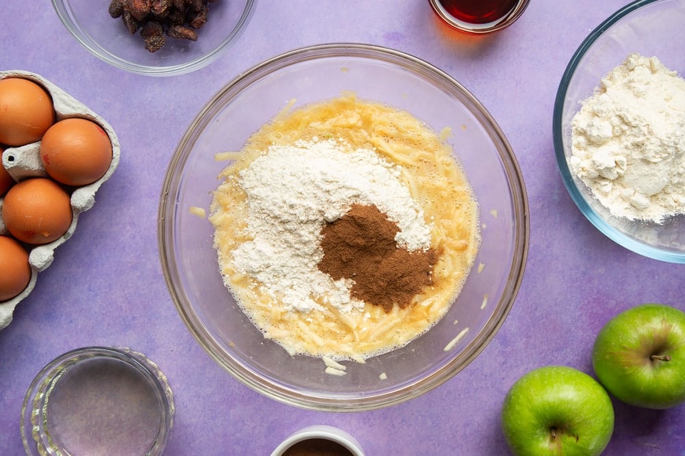 No junk apple and strawberry muffins - flour and cinnamon added to a bowl.