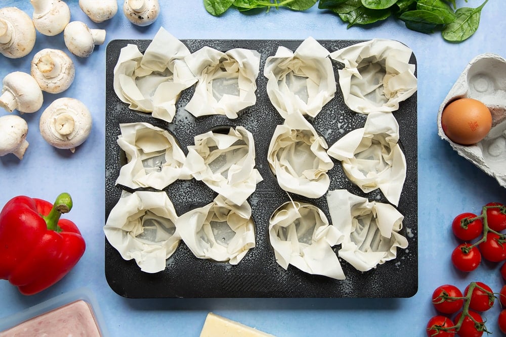 Filo pastry mini quiches - one filo sheet pushed into each muffin hole.