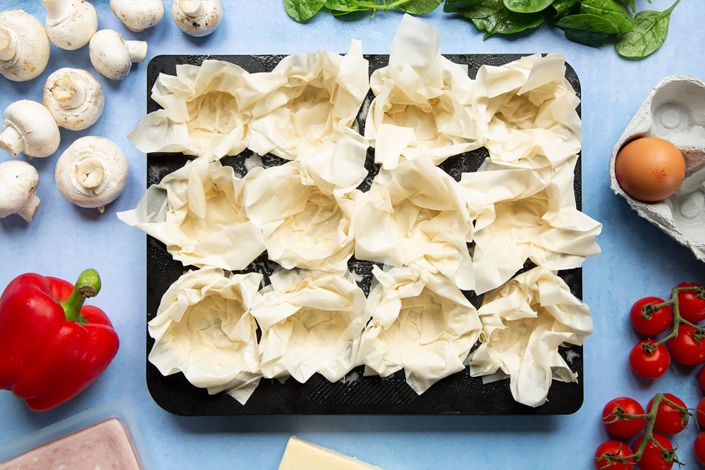 Filo pastry mini quiches - three filo sheets pushed into each muffin hole.