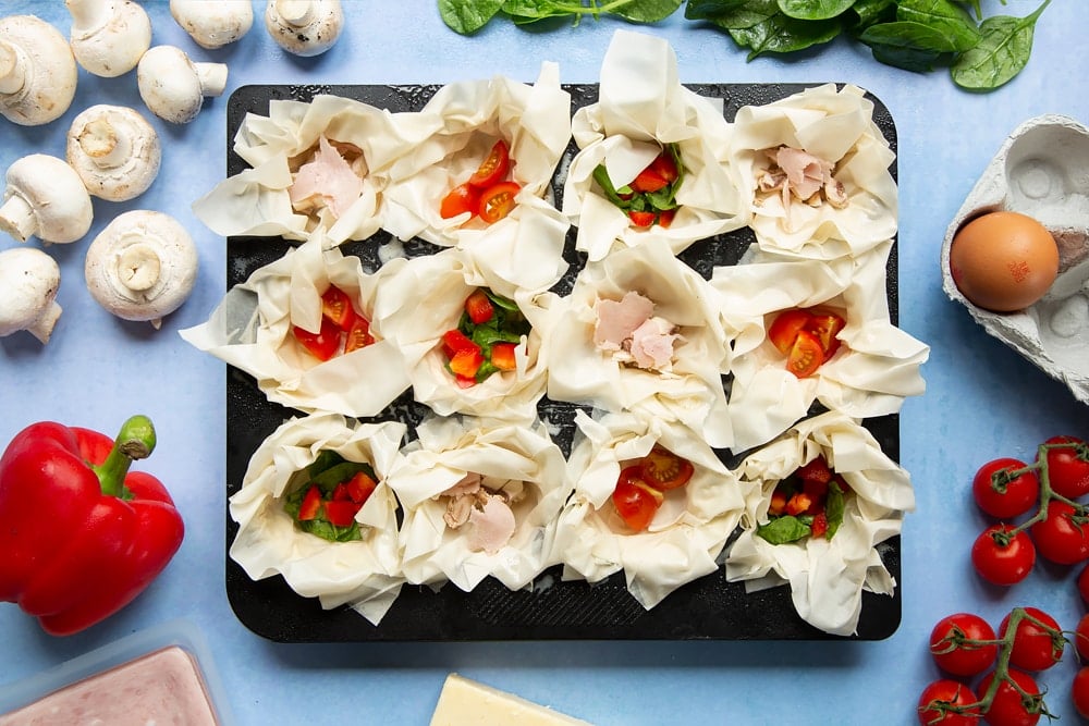 Filo pastry mini quiches - vegetable fillings added to filo pastry cases.