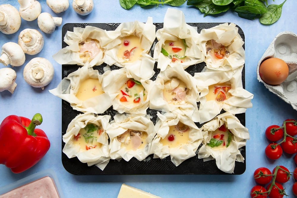 Filo pastry mini quiches - vegetable fillings and egg added to filo pastry cases.
