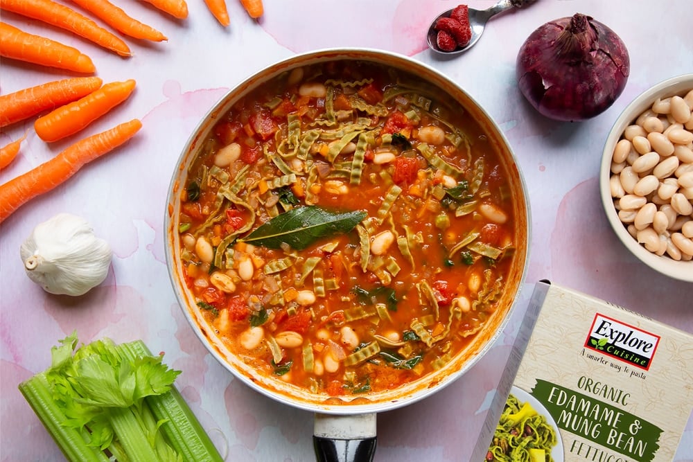 A frying pan containing the sauce with the fettuccine pasta and cannellini beans mixed in and simmered for 5 minutes.