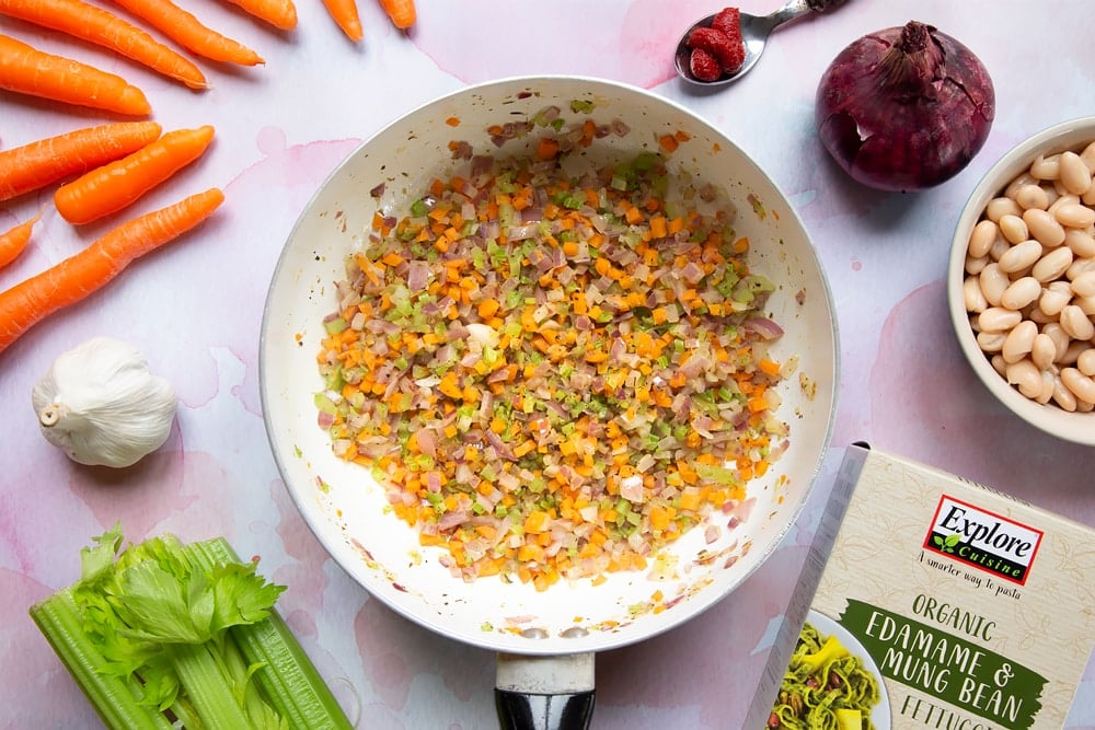 Cooked carrots, celery, onion, garlic, oregano, salt and pepper in a frying pan.