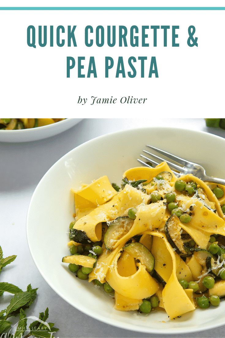 Close up shot of the courgette and pea pasta in a white bowl with a fork. At the top of the image there's some text describing the image for Pinterest.