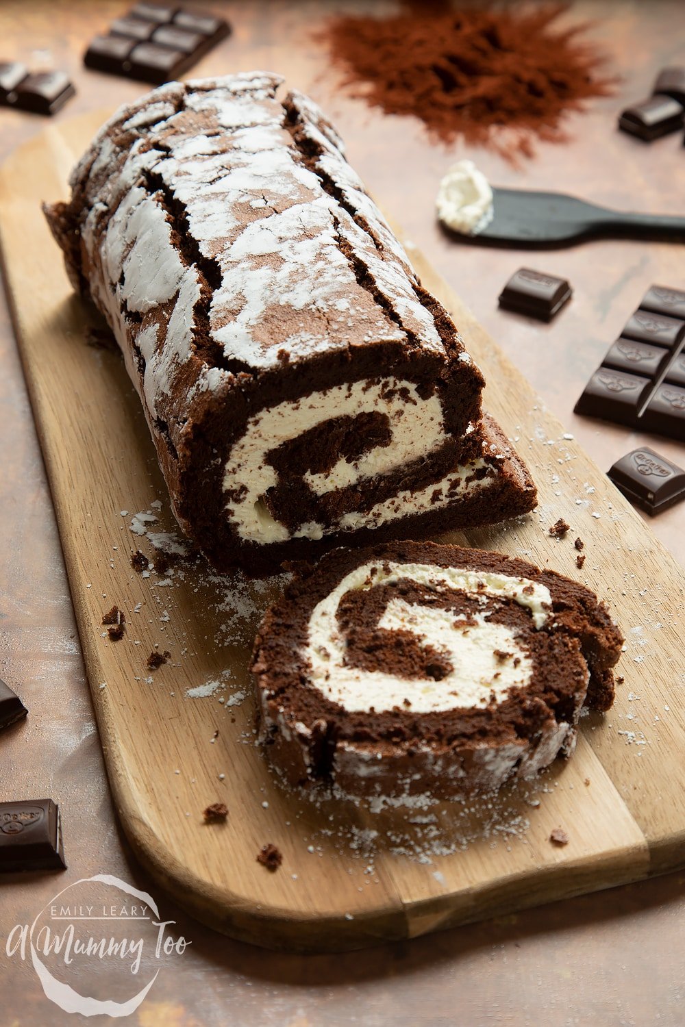 Mary Berry's chocolate roulade, shown, with a slice on a board.