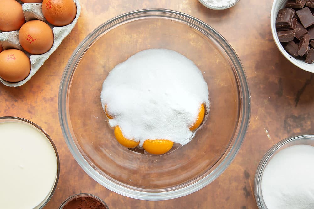 Egg yolks and caster sugar in a mixing bowl.